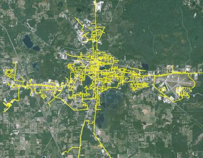 The layout of gas lines in the city is drawn, in yellow, onto a satellite image of Lake City.  