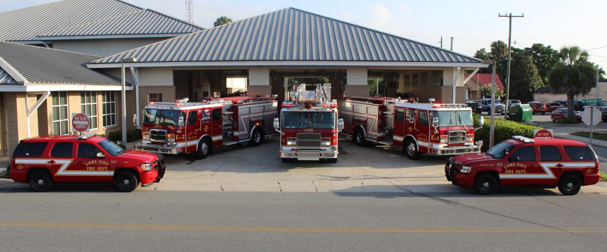 Three fire engines and two chief vehicles parked in front of the Lake City fire station